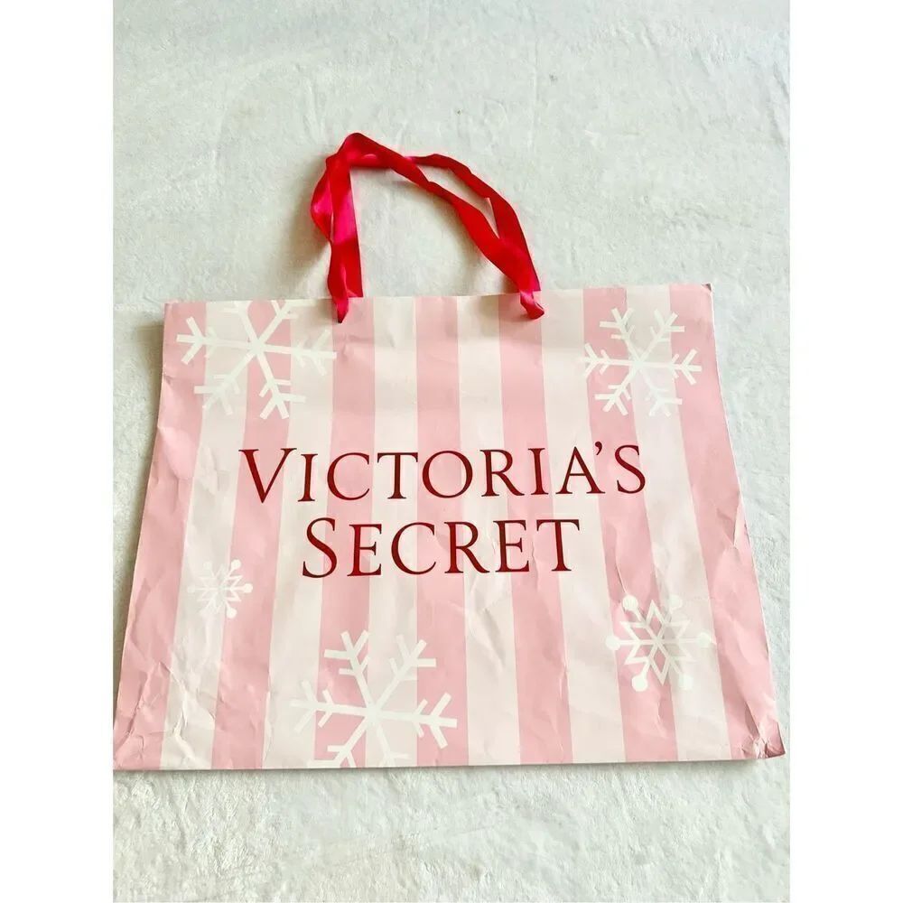 Victoriaโs Secret large holiday light pink andโred gift bag tote with snowflakes